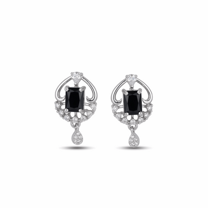 Pair of earrings with black gemstones and diamond accents on a white background