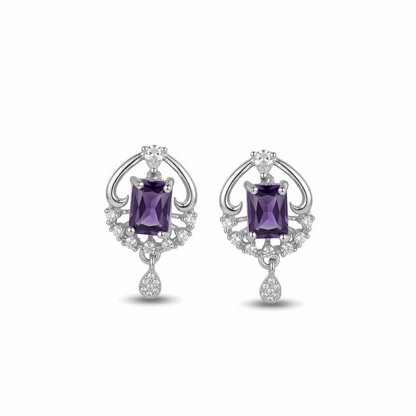 Pair of silver earrings with purple gemstones on a white background