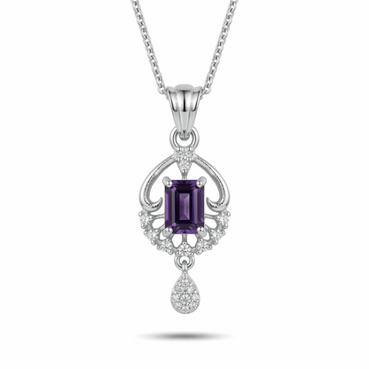 Silver pendant with a purple gemstone on a white background