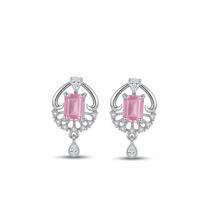 Pair of earrings with pink gemstones and diamond accents on a white background