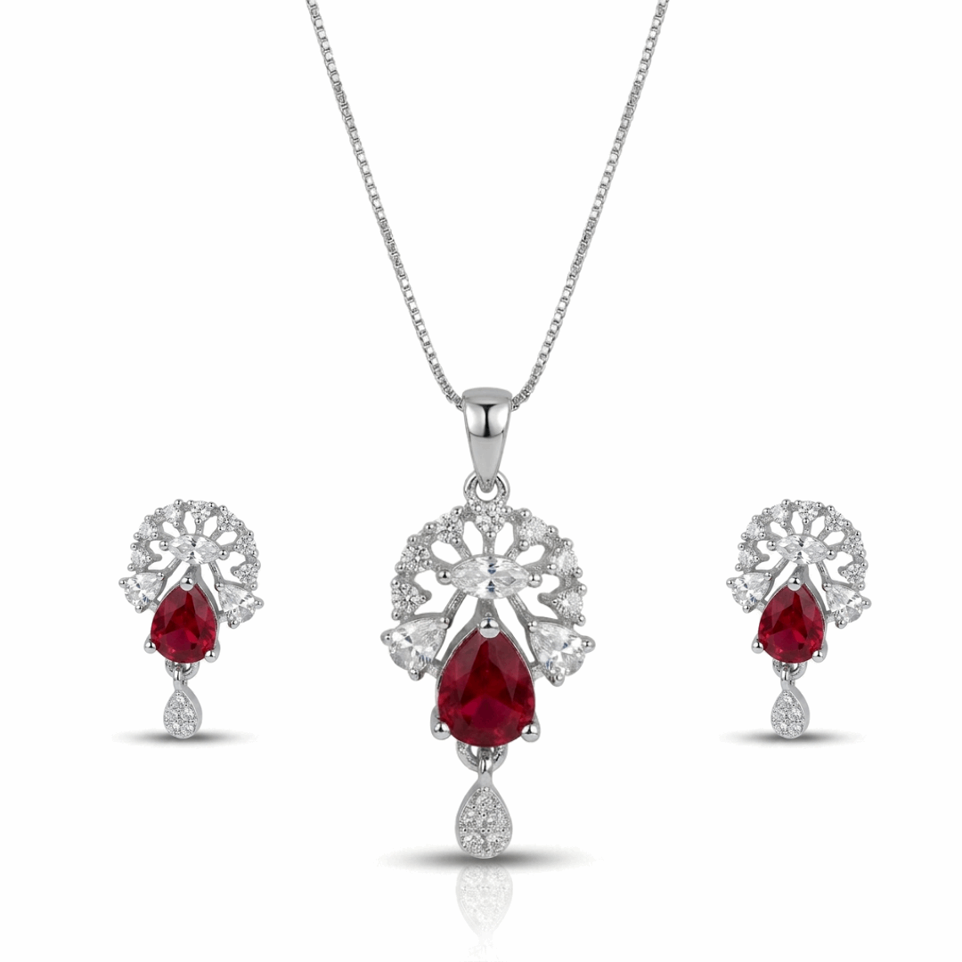 Jewelry set with red gemstones and silver designs on a white background