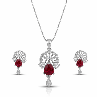 Jewelry set with red gemstones and silver designs on a white background
