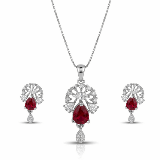 Jewelry set with red gemstones and silver designs on a white background