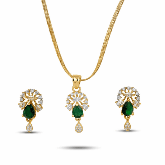 Gold jewelry set with emerald and diamond accents on a white background