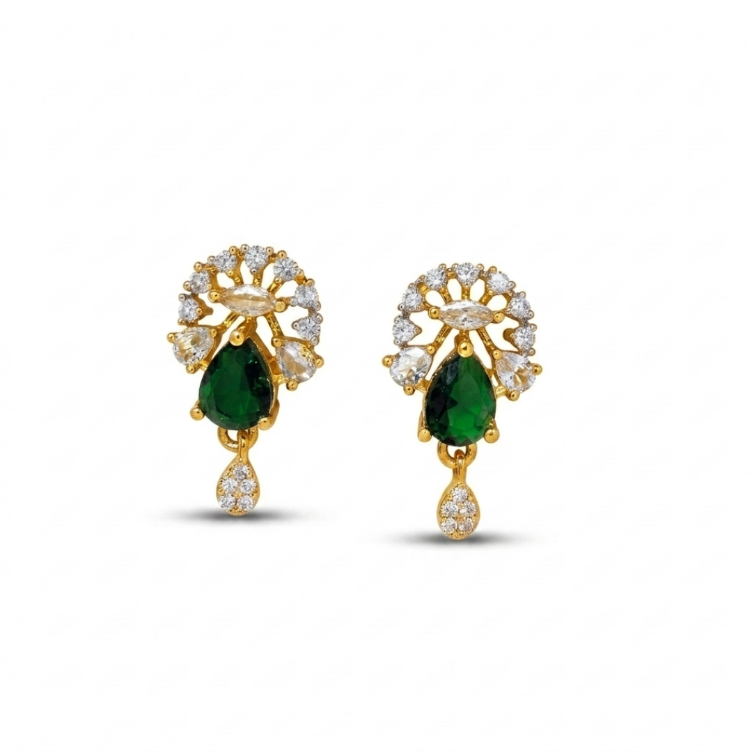 Gold earrings with green gemstones on a white background