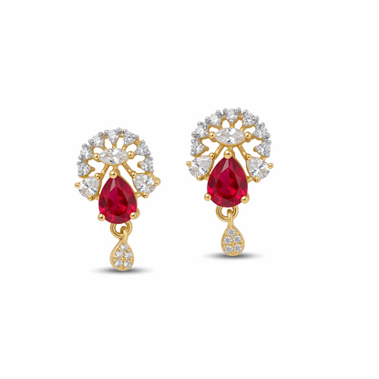 Gold earrings with red gemstones and diamond accents on a white background