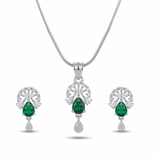 Jewelry set with emerald green gemstones on a white background