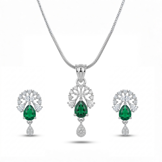 Jewelry set with emerald green gemstones on a white background