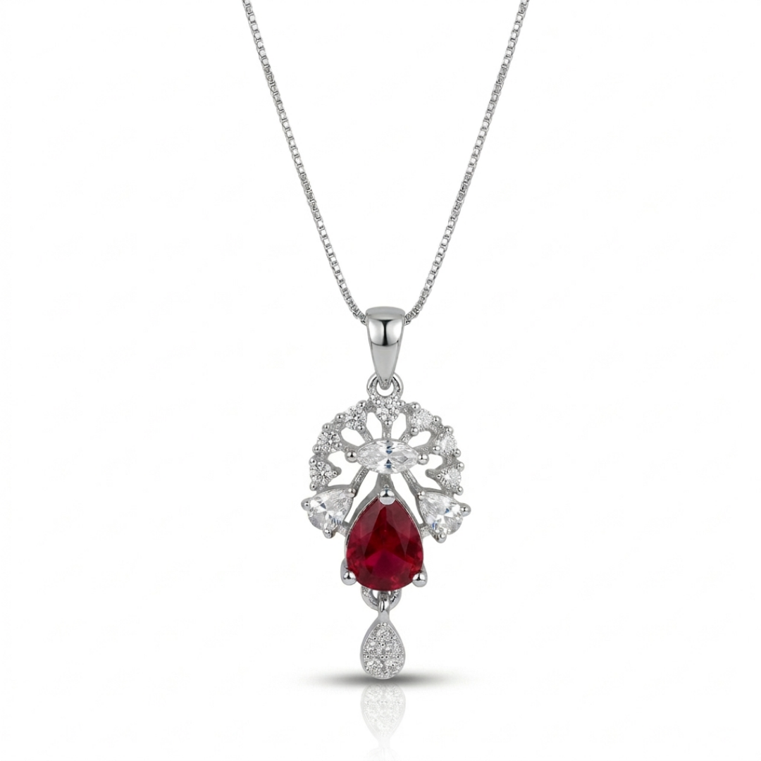Silver necklace with a red gemstone pendant on a white background