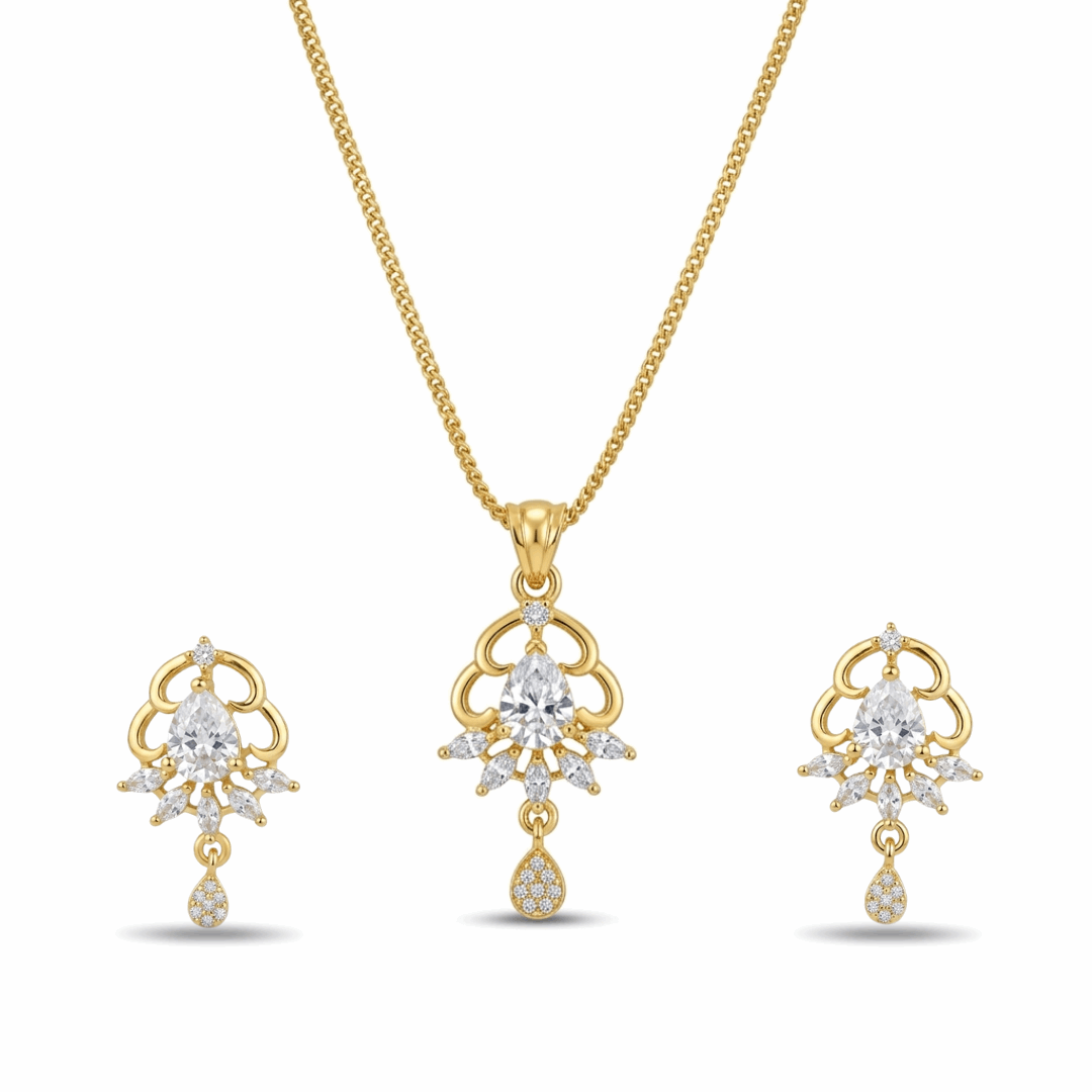 Gold necklace and earrings set with clear gemstones on a white background