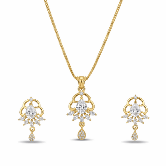 Gold necklace and earrings set with clear gemstones on a white background