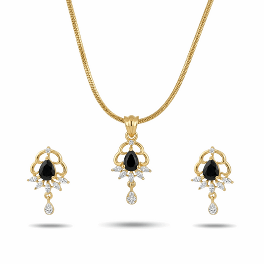 Gold necklace and earrings set with black gemstones on a white background