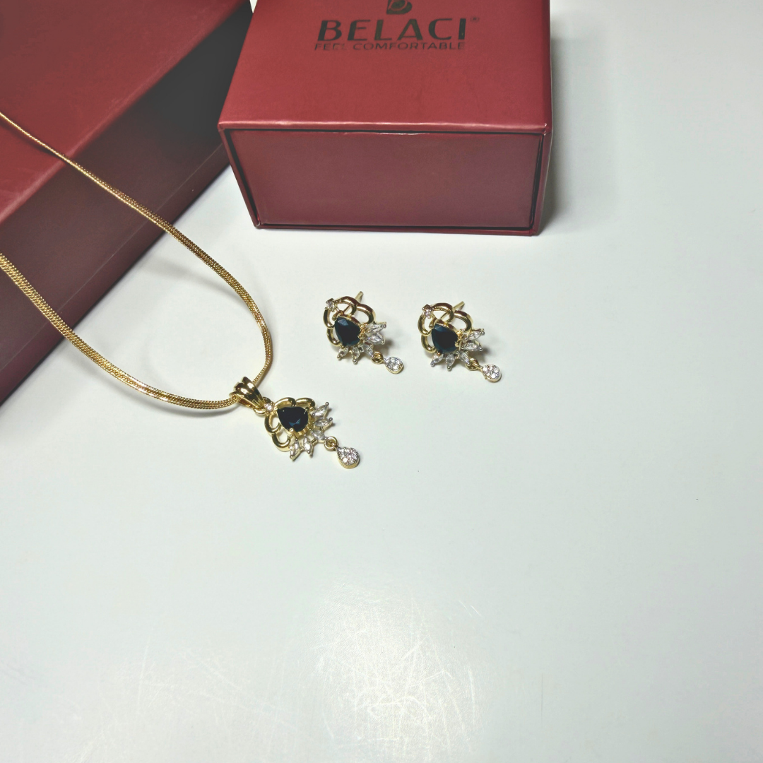Jewelry set with necklace and earrings on a white surface, Belaci box in the background.