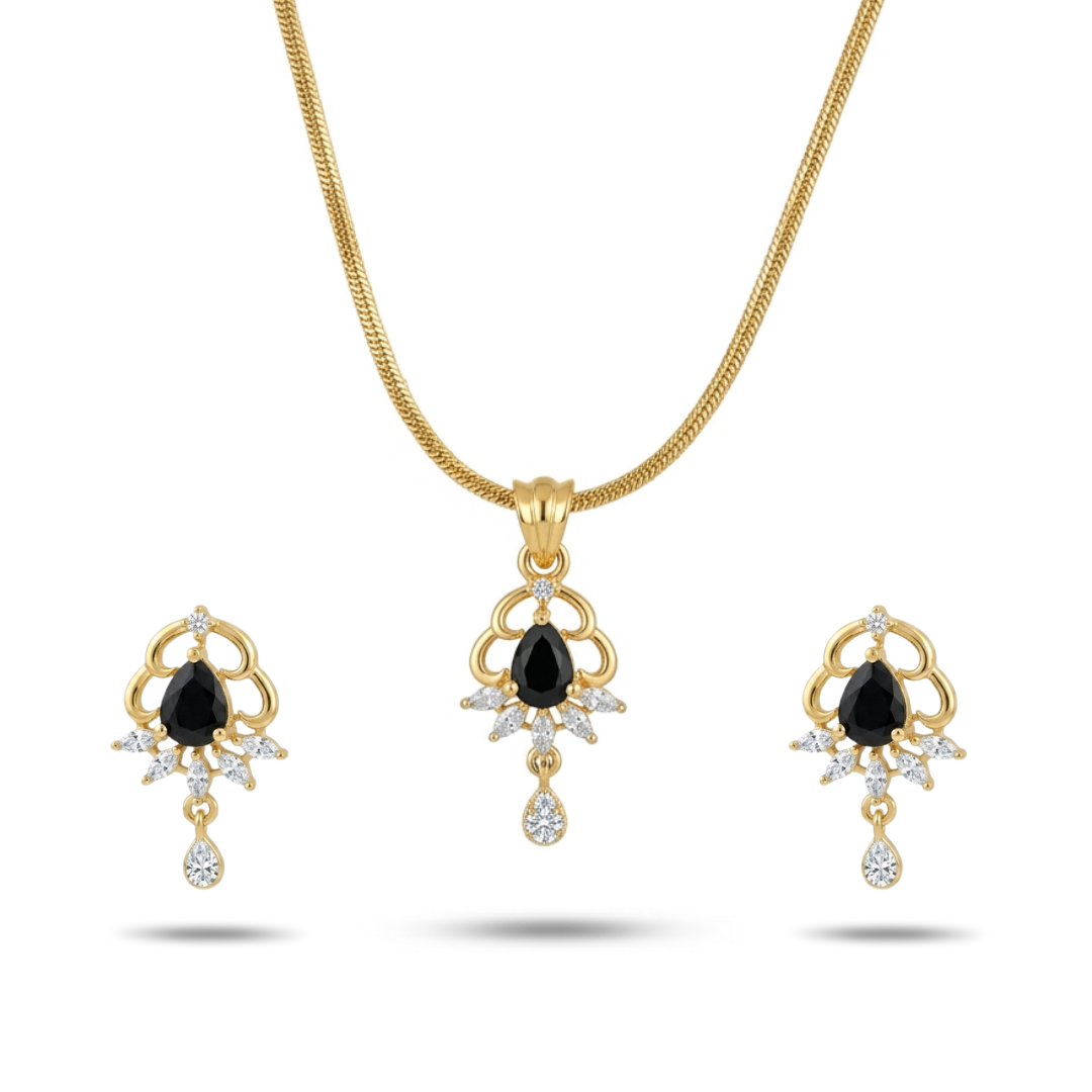 Gold necklace and earrings set with black gemstones on a white background