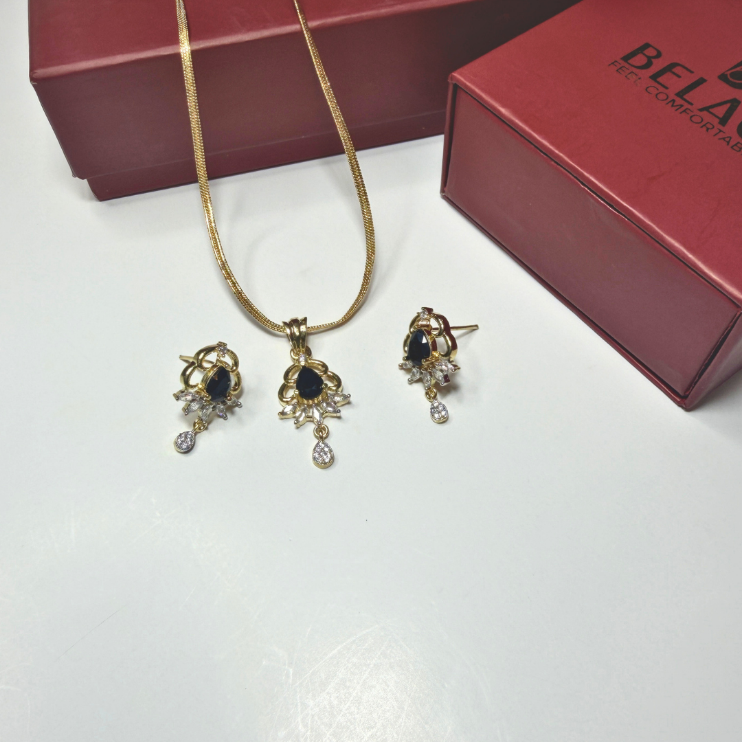 Jewelry set with necklace and earrings on a white surface with a red box in the background.