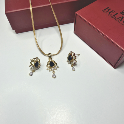 Jewelry set with necklace and earrings on a white surface with a red box in the background.