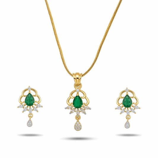 Gold necklace and earrings set with green gemstones on a white background