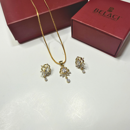Jewelry set with necklace and earrings on a white surface, Belaci box in the background.