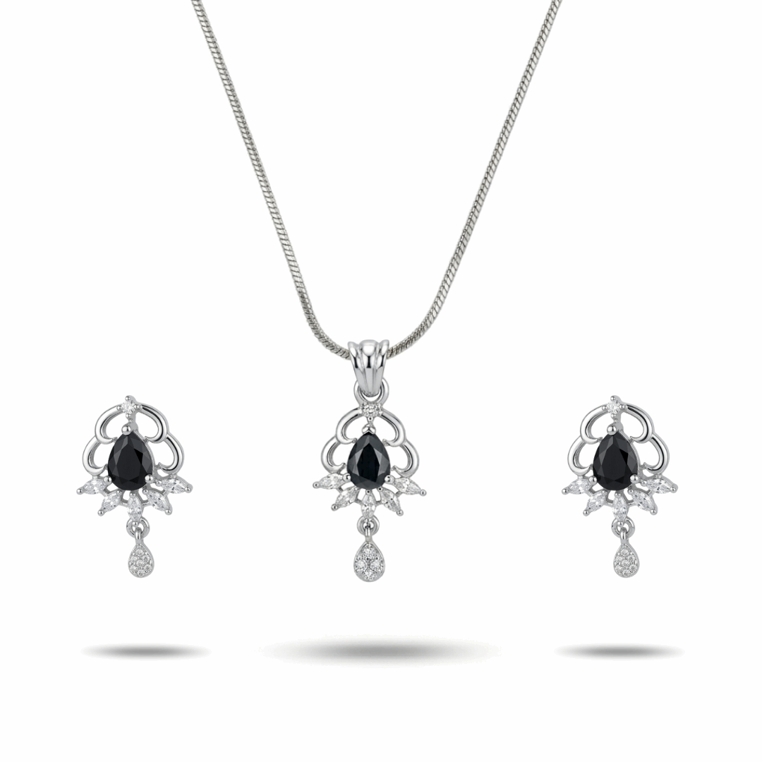 Jewelry set with necklace and earrings featuring black gemstones on a white background