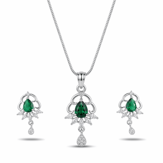 Jewelry set with emerald green gemstones on a white background