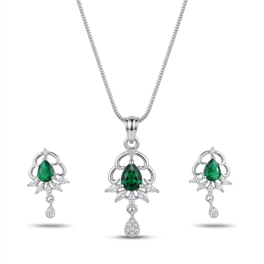 Jewelry set with emerald green gemstones on a white background
