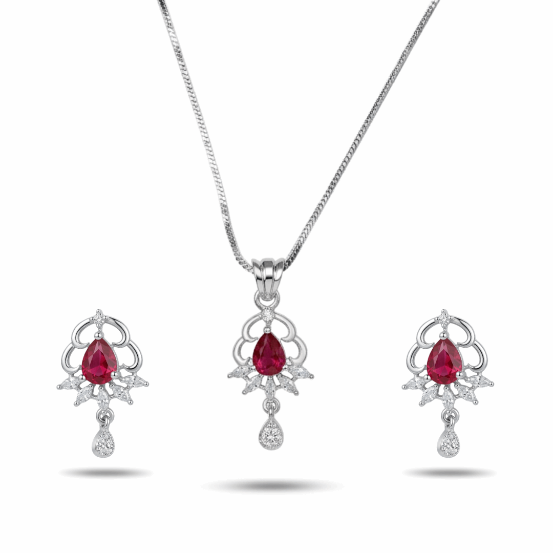 Jewelry set with red gemstones and silver designs on a white background