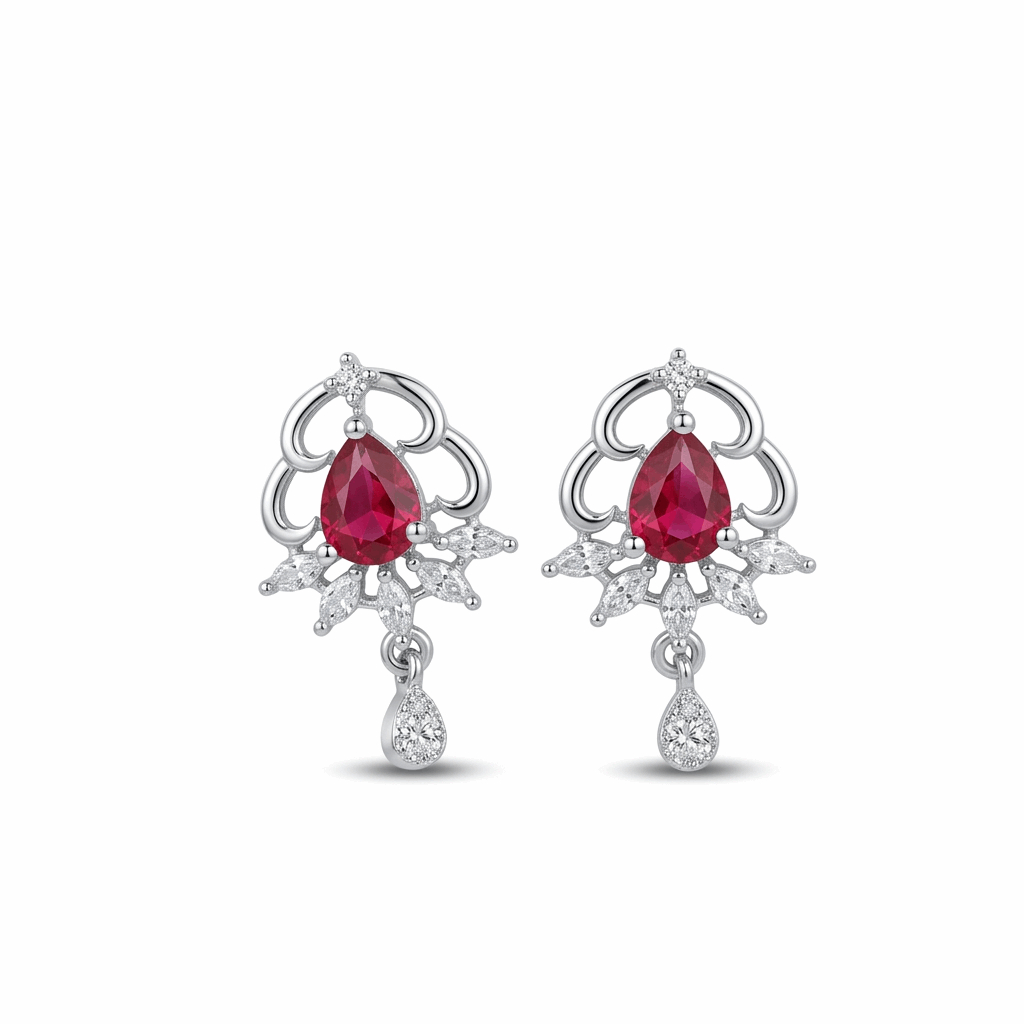 Pair of earrings with red gemstones and silver designs on a white background