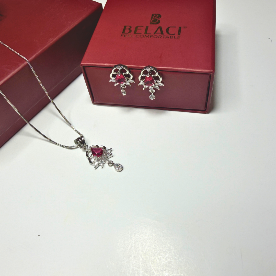 Jewelry set with necklace and earrings in front of a BELACI box on a white background