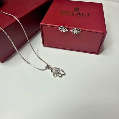 Silver necklace with floral pendant in front of a red BELACI box on a white background