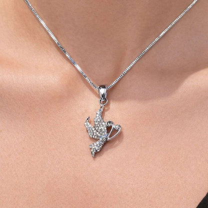 Silver necklace with a detailed pendant on a person's neck