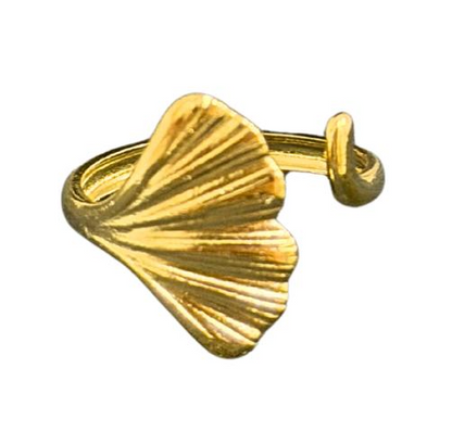 Close-up of a hand with a gold Ring for Women on a warm-toned background