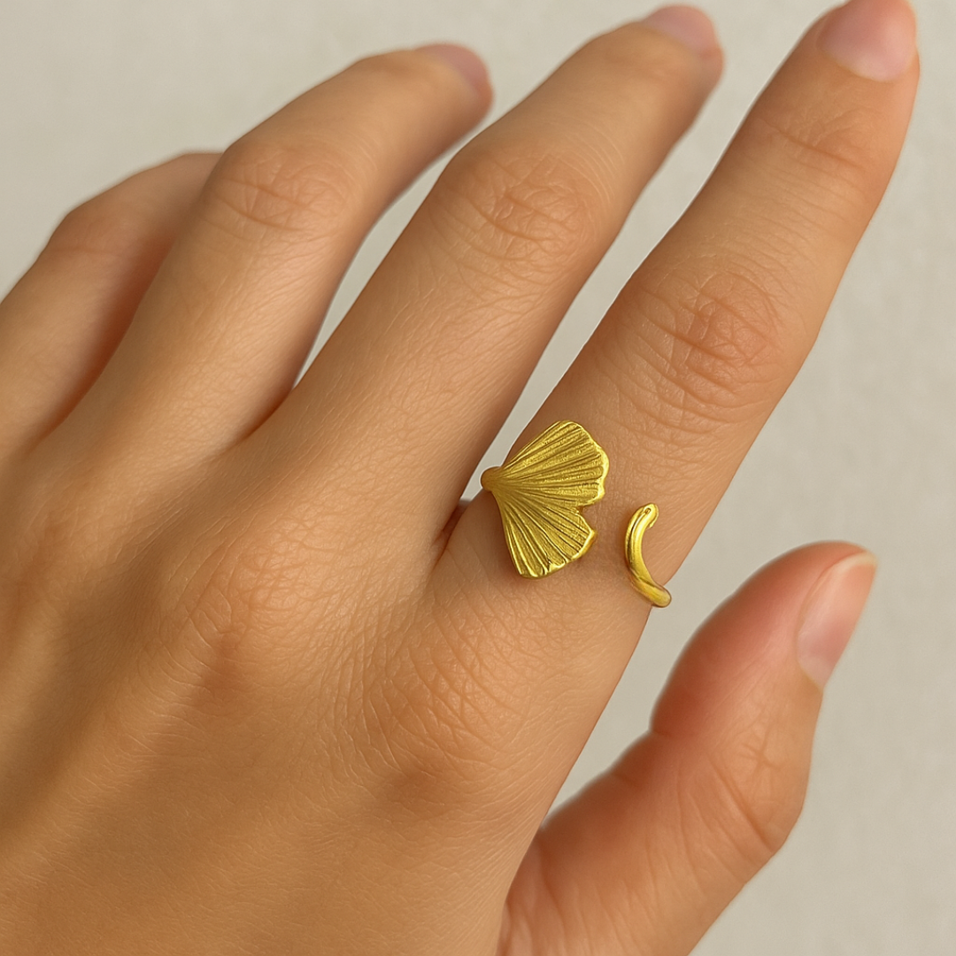 Gold Ring for Women with leaf and moon design on a hand against a neutral background
