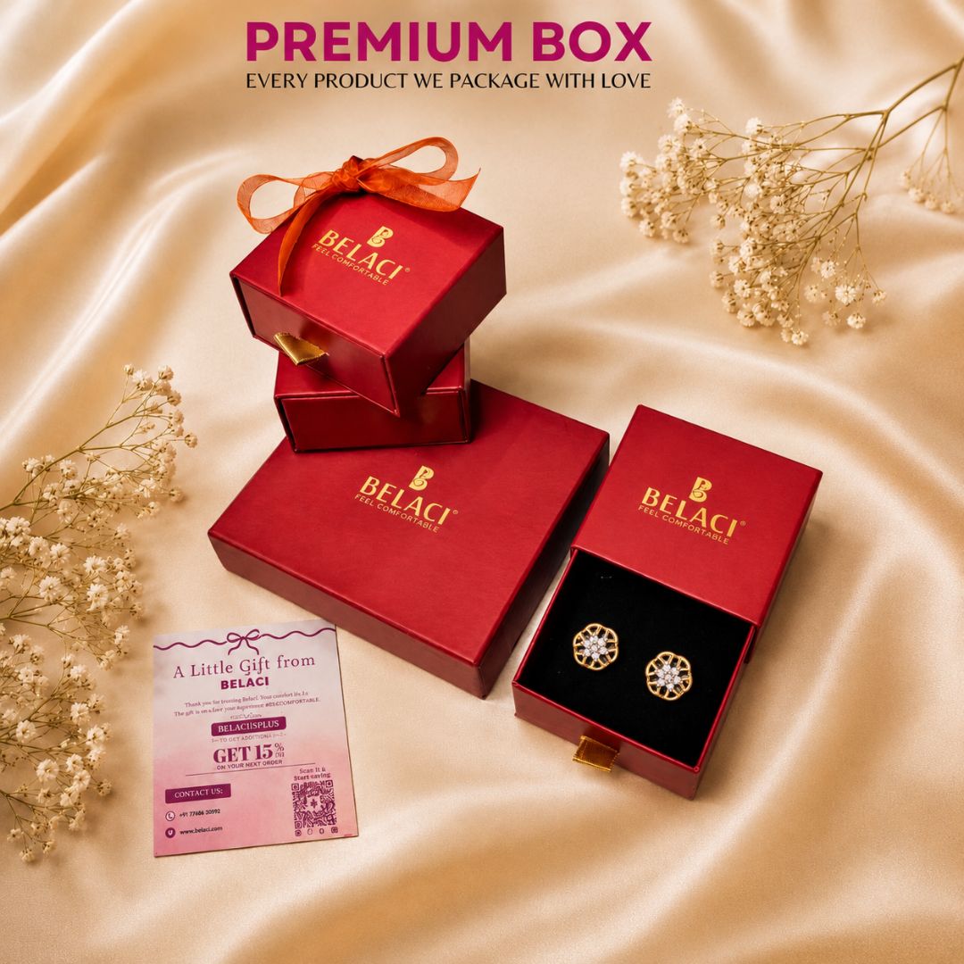 BELACI premium jewelry gift packaging set featuring red boxes and an open box displaying round gold-toned earrings with clear stones, arranged on a beige satin fabric with baby's breath flowers and a promotional card.