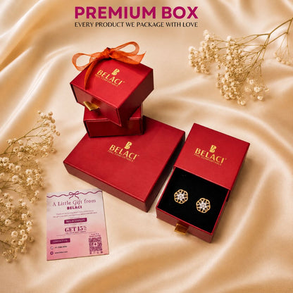 BELACI premium jewelry gift packaging set featuring red boxes and an open box displaying round gold-toned earrings with clear stones, arranged on a beige satin fabric with baby's breath flowers and a promotional card.