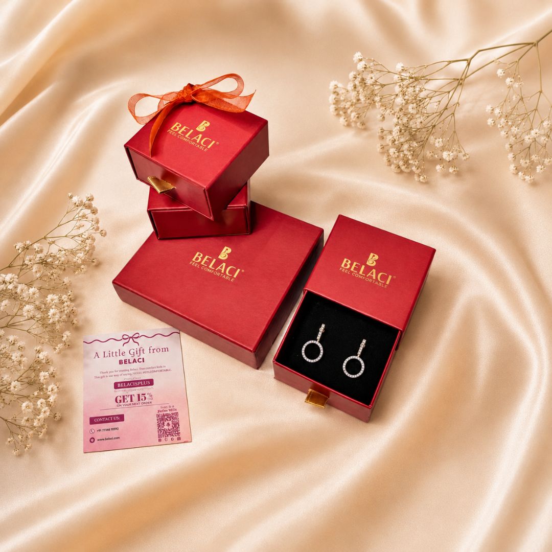 Belaci jewelry gift set with circular earrings in red boxes and a discount card on satin fabric
