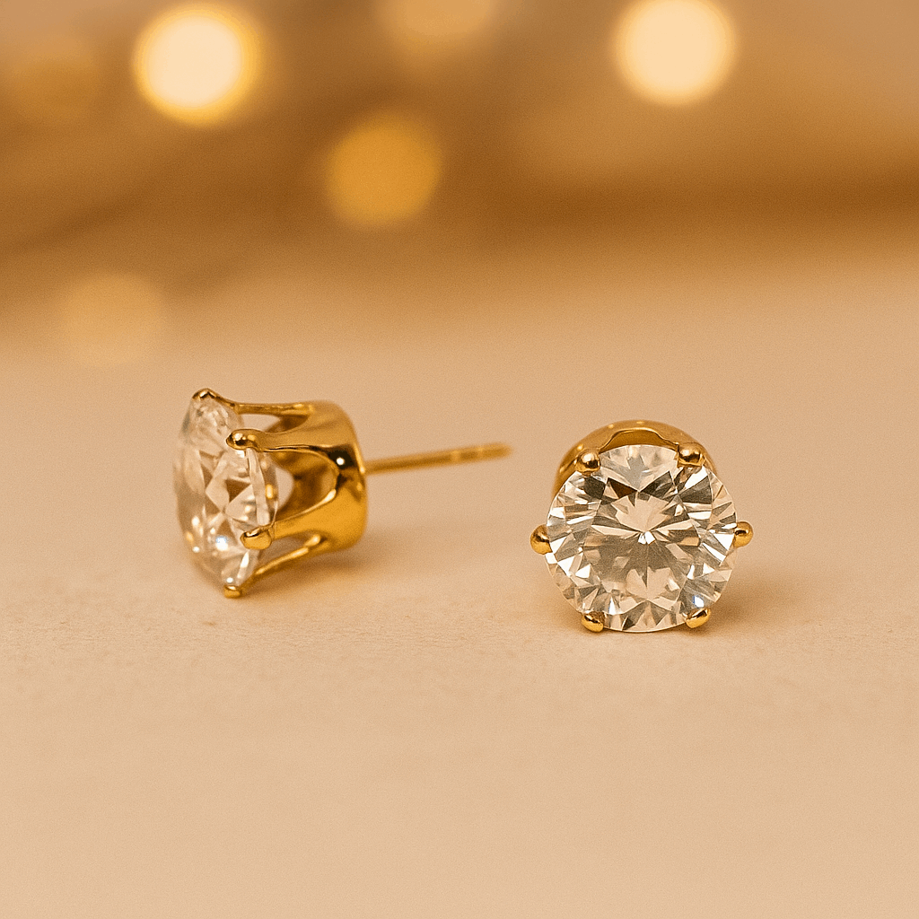 Gold stud Earrings for Women with clear gemstones on a beige background