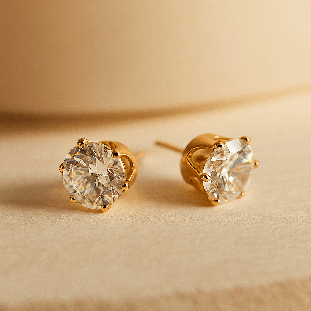 Gold stud Earrings for Women with clear gemstones on a beige background