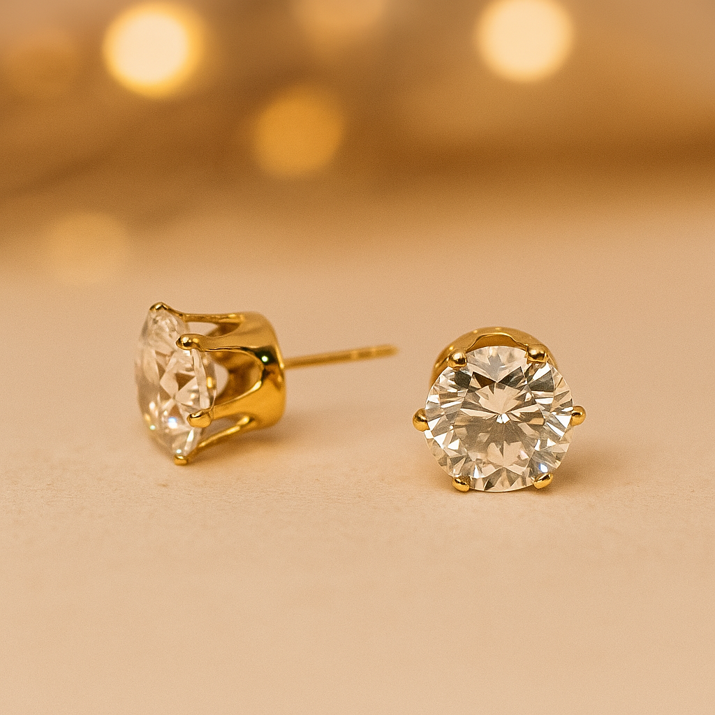 Gold stud Earrings for Women with clear gemstones on a beige background