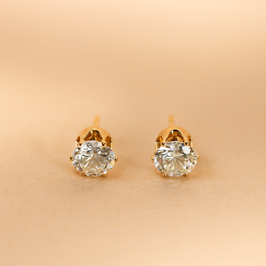 Gold Earrings for Women with clear gemstones on a beige background