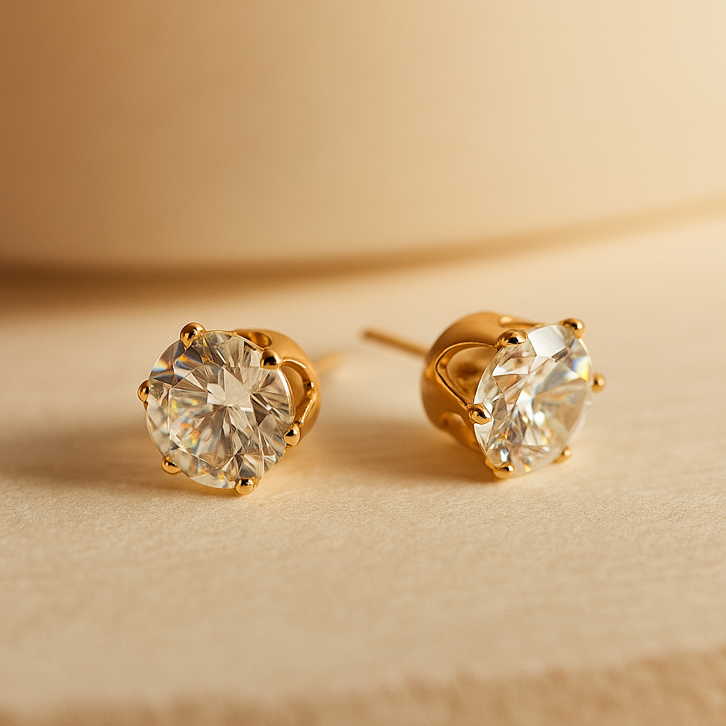 Gold stud Earrings for Women with clear gemstones on a beige background