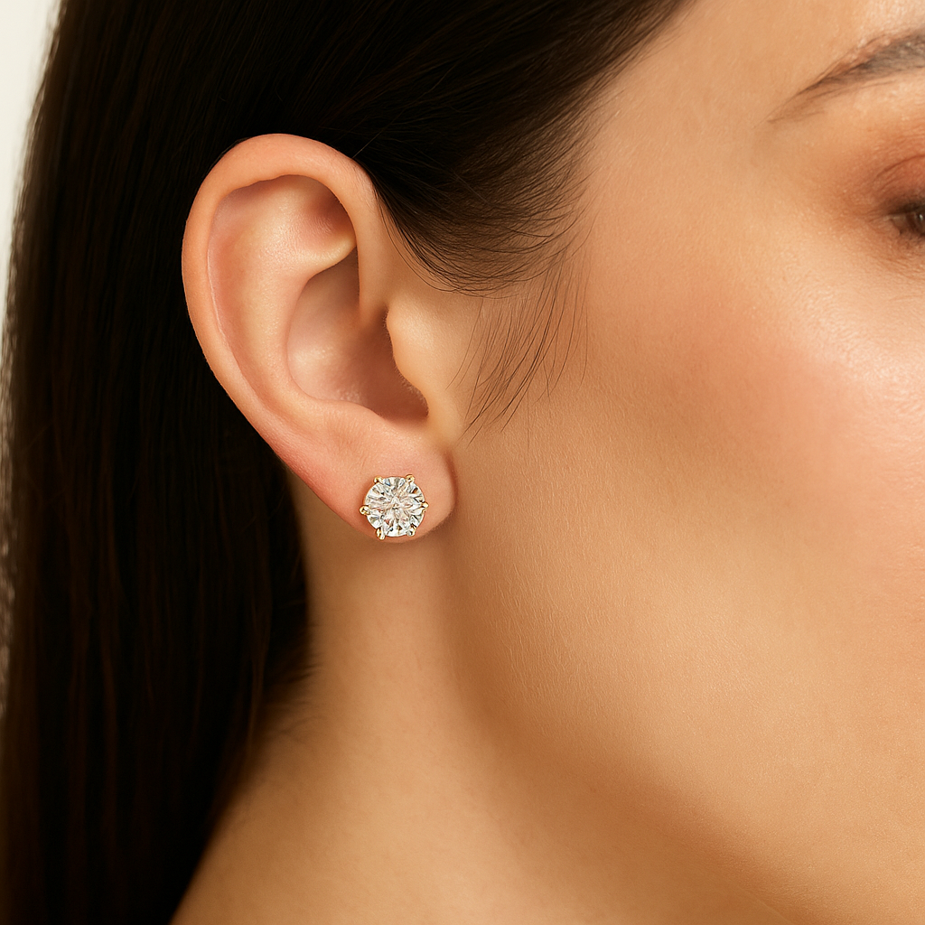 Close-up of a woman's ear wearing a diamond earring with a blurred background