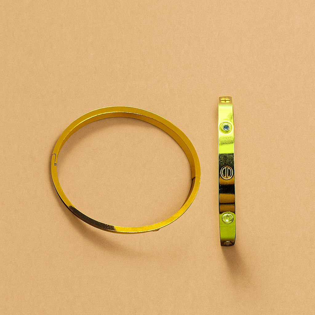 Gold Bracelet for Women with green gemstones on a beige background