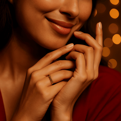 Close-up of a hand with a gold Ring for Women on a warm-toned background