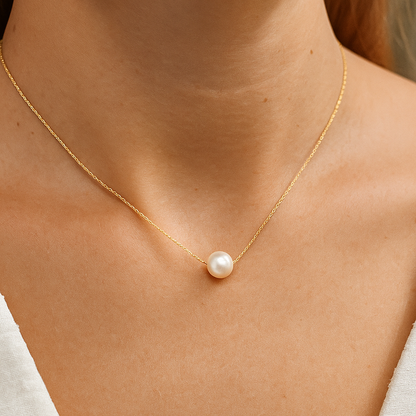 Gold necklace with a single pearl Pendant for Women on a person's neck