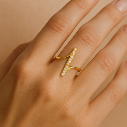 Close-up of a hand with a gold Ring for Women on a warm-toned background
