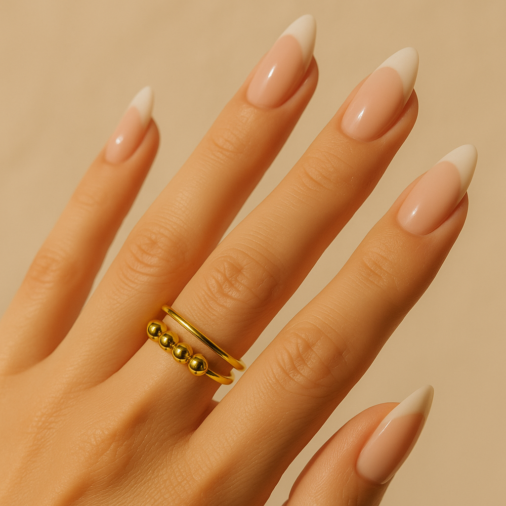 Close-up of a hand with a gold Ring for Women on a warm-toned background