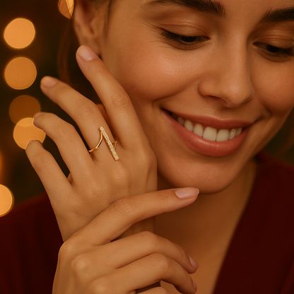 Close-up of a hand with a gold Ring for Women on a warm-toned background