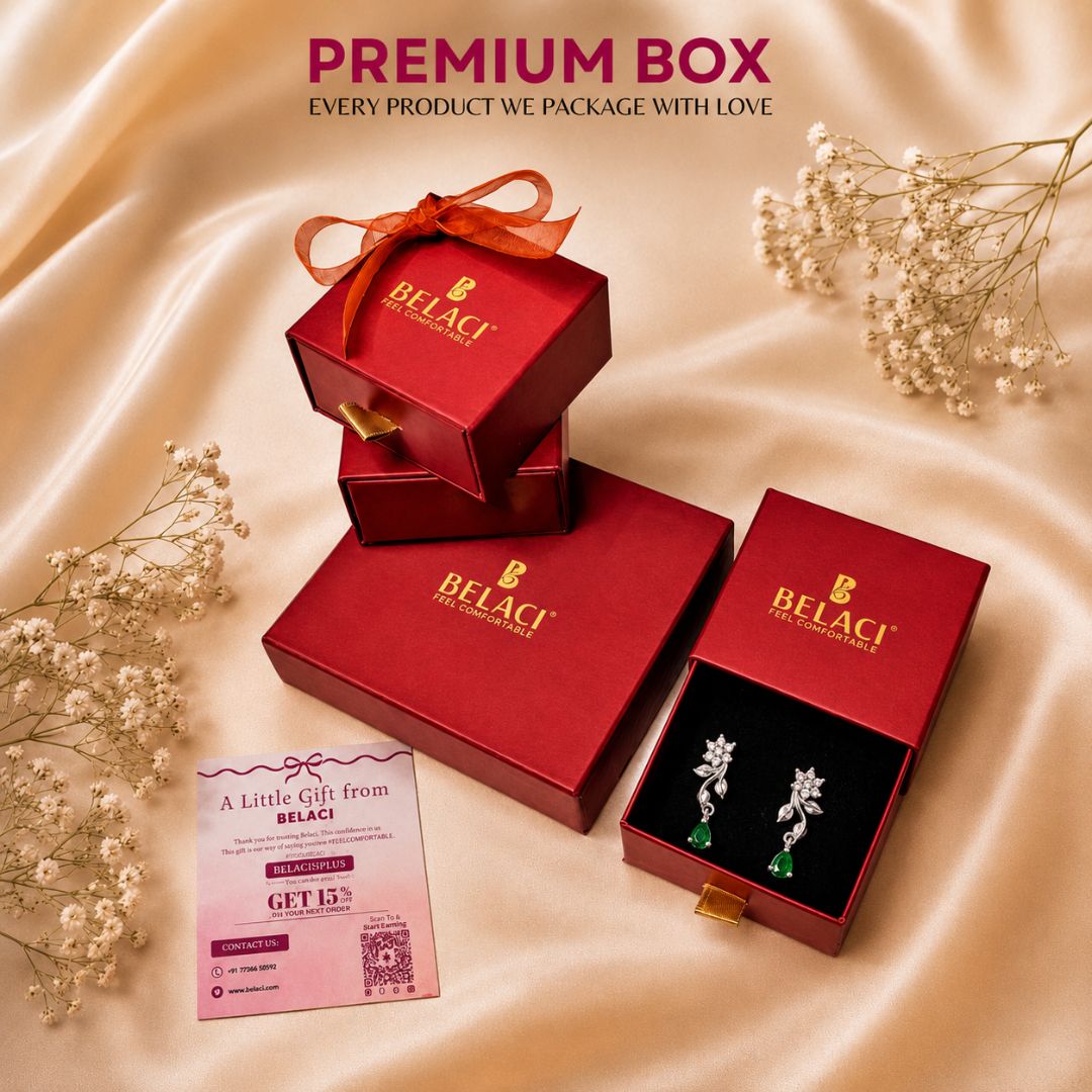 BELACI premium jewelry packaging and an open display box showing silver floral earrings with green stones, arranged on beige satin with small white flowers and a gift card. Text at the top reads PREMIUM BOX.