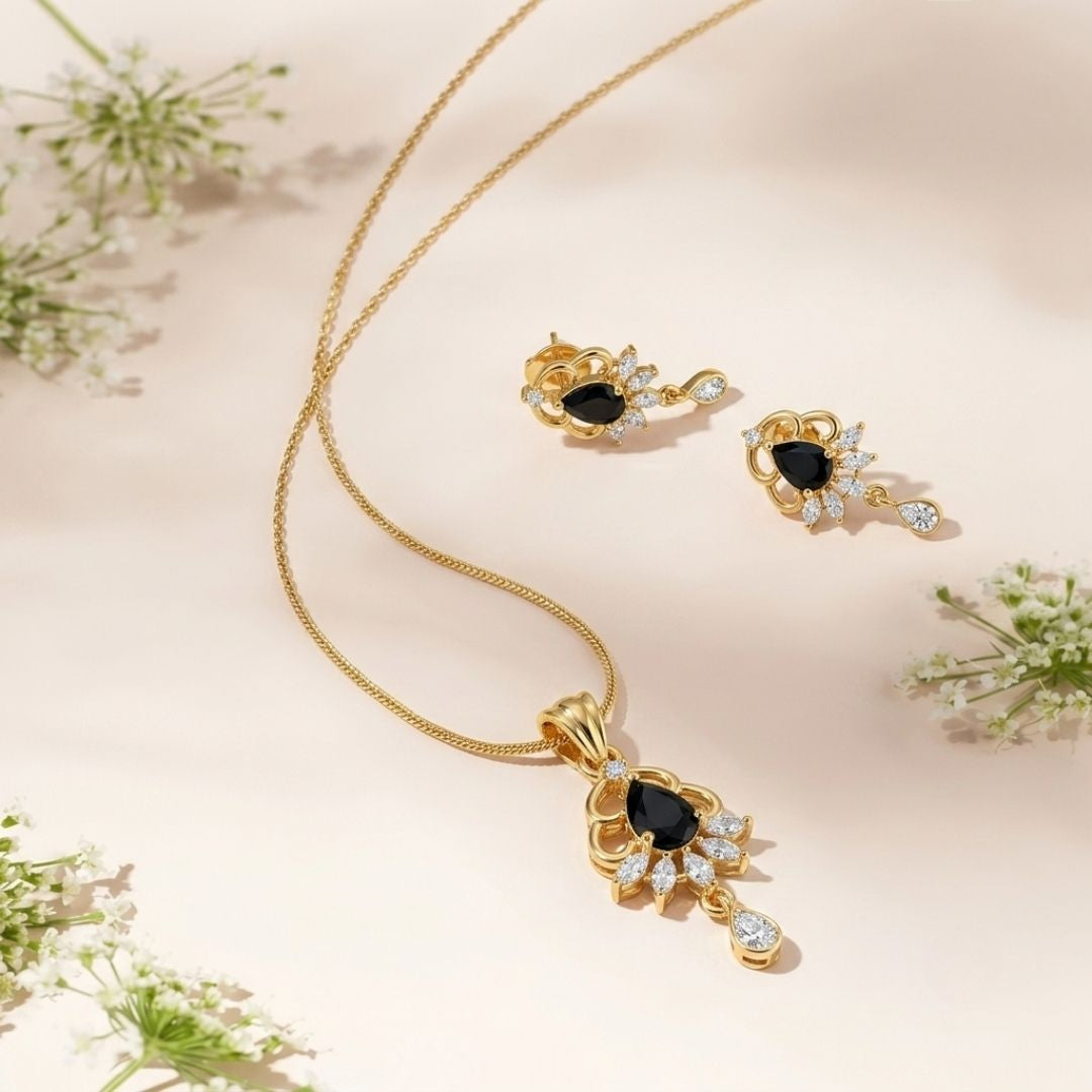 Gold necklace and earring set with pear shaped black stones and small white accent stones