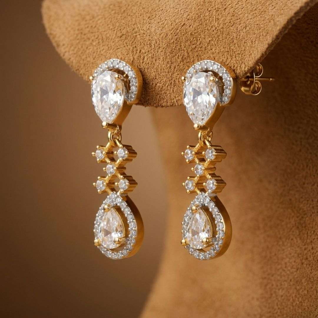 Gold and diamond earrings on a brown velvet stand